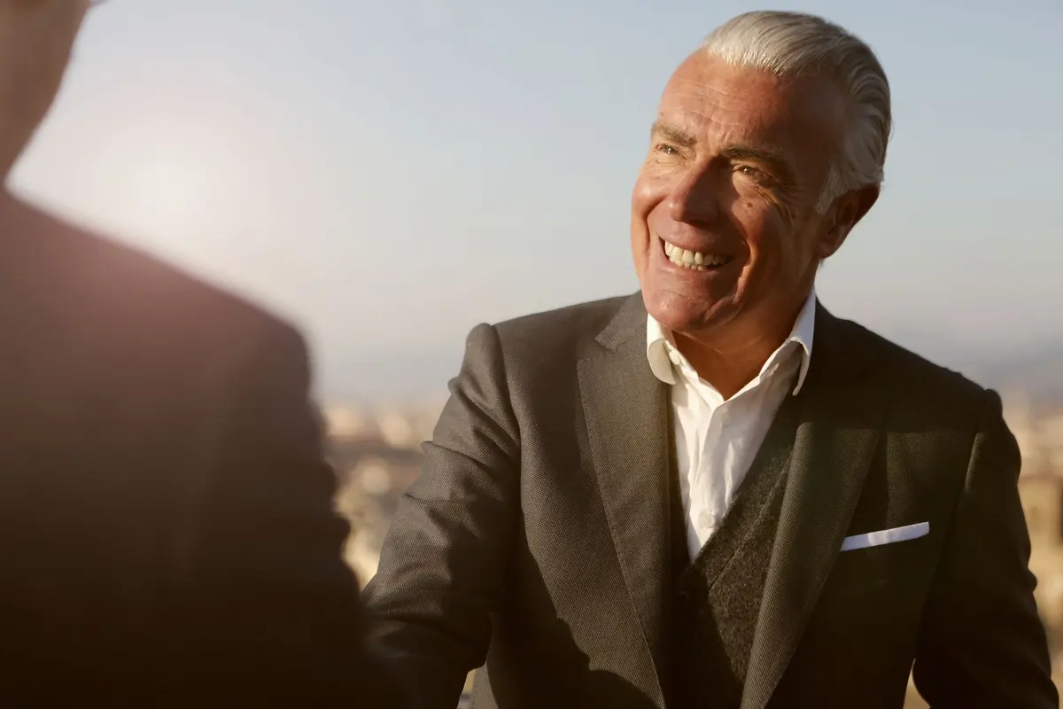 Senior business leader smiling as he shakes hands on a new deal