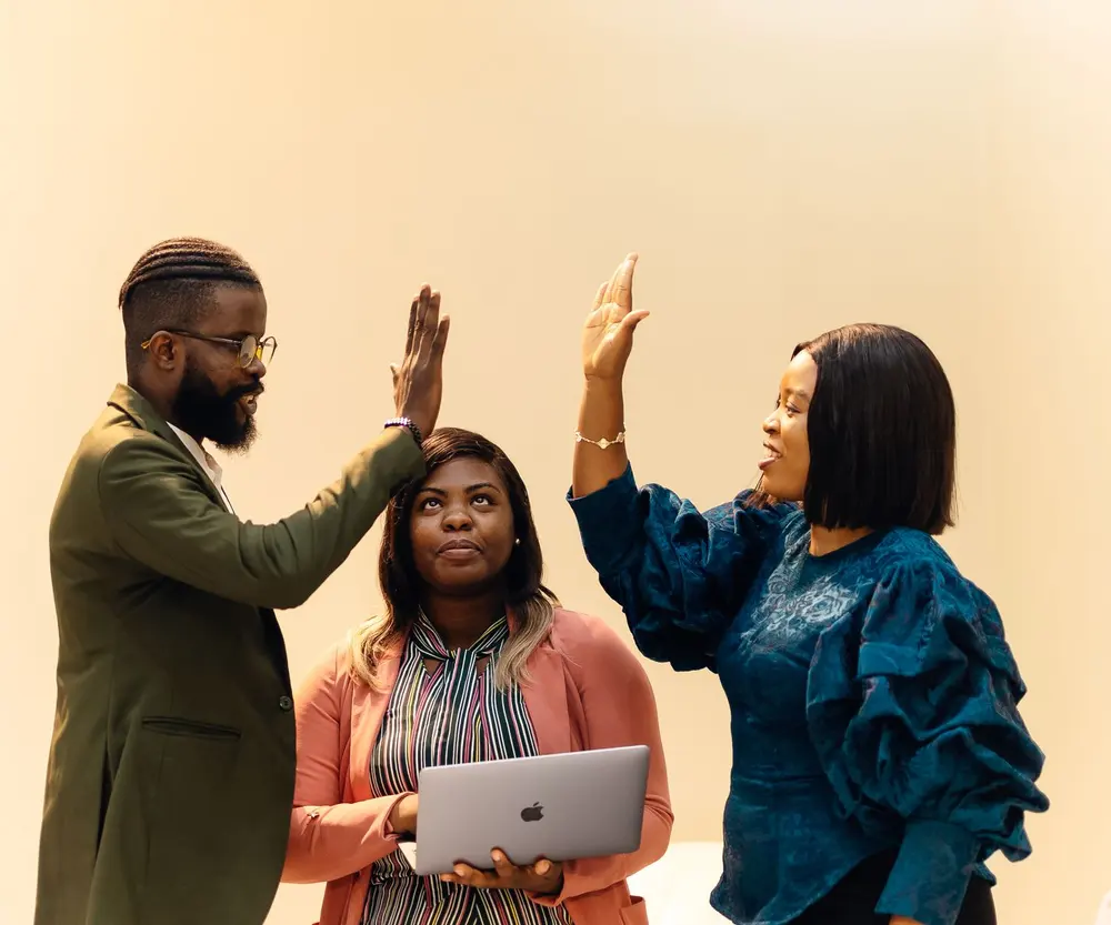 Colleagues high-fiving after closing a deal